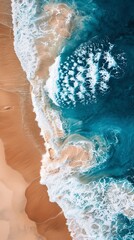 Aerial view of vibrant ocean waves crashing against a sandy beach, showcasing beautiful patterns and textures in nature.