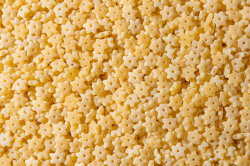 Uncooked Stelline Pasta: A Culinary Canvas of Stelline Macaroni, Creating a Lively and Textured Background for Gourmet Cooking. Dry Pasta. Raw Macaroni - Top View, Flat Lay