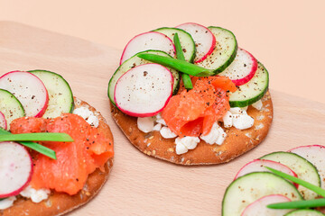 Crispy Cracker Sandwiches with Fresh Salmon, Cucumber, Radish, Cottage Cheese and Green Onions. Easy Breakfast. Quick and Healthy Sandwiches. Crispbread with Tasty Filling. Healthy Dietary Snack