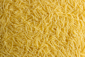 Uncooked Filini Pasta: A Culinary Canvas of Noodles, Creating a Lively and Textured Background for Gourmet Cooking. Dry Pasta. Raw Macaroni - Top View, Flat Lay