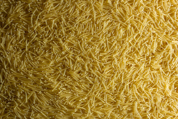 Uncooked Filini Pasta: A Culinary Canvas of Noodles, Creating a Lively and Textured Background for Gourmet Cooking. Dry Pasta. Raw Macaroni - Top View, Flat Lay