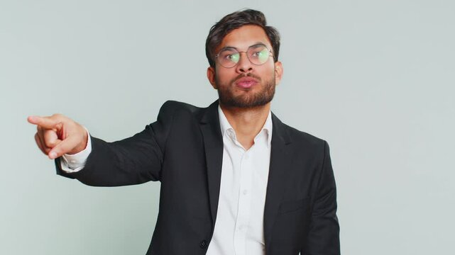 Get out of here. You are fired. Irritated Indian businessman pointing finger away asking to leave him alone, strict boss firing, conflict, quarrel. Male Arabian man guy isolated on gray background