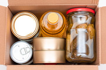 Food Reserves or Donation Box: Carton Box with Canned Food, Cereals and Grocery. Emergency Food Storage in Case of Crisis. Free Social Help, Blessings and Care. Strategic Food Supplies