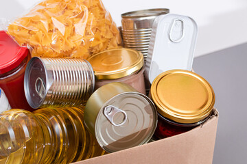 Donation Box of Free Food. Carton Box with Canned Food, Cereals and Grocery. Meal Reserves. Emergency Food Storage in Case of Crisis. Free Social Help, Blessings and Care. Strategic Food Supplies