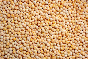 Uncooked Yellow Polished Peas Background. A Culinary Canvas of Dry Yellow Peas, Creating a Lively and Textured Background for Gourmet Cooking. Scattered Raw Polished Peas. Healthy Eating Ingredients