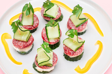 Canapes without Bread with Salami, Cucumber, Greens and Cream Cheese on White Plate. Easy Breakfast. Diet Food. Quick and Healthy Sandwiches. Healthy Snacks with Tasty Fillings
