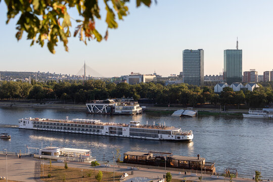 Modern river cruiser 'Viking Vidar' (ship, 2015) in Belgrade on Sava river continues his journey to Danube, Serbia. Panorama of New Belgrade in background