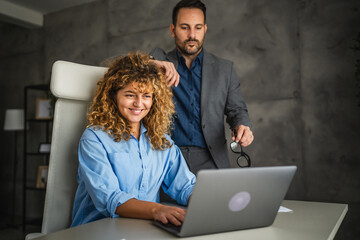 colleagues work together on laptop and from information from envelope