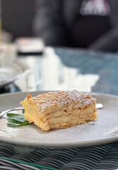 This is a delicious layered dessert presented beautifully on a modern, stylish plate
