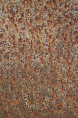Texture or background of the walls of rusted steel sheets are an orange color, very dark and abstract.