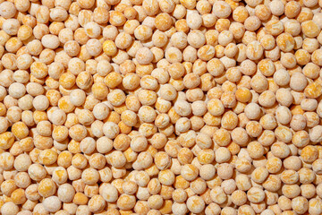Uncooked Yellow Polished Peas Background. A Culinary Canvas of Dry Yellow Peas, Creating a Lively and Textured Background for Gourmet Cooking. Scattered Raw Polished Peas. Healthy Eating Ingredients
