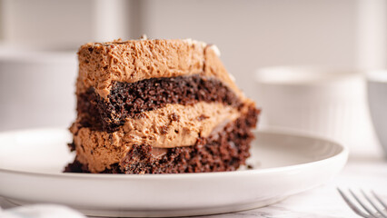 Chocolate Cake Slice on White Plate – Selective Focus

