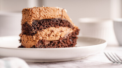 Chocolate Cake Slice on White Plate – Selective Focus

