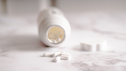 Pain Relief Tablets Falling Out of Bottle for Fever and Pain Relief