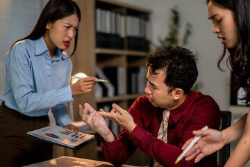 A woman is pointing at a piece of paper and the man is looking at her