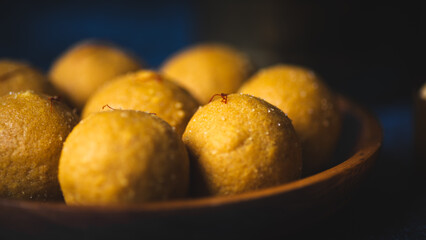 Traditional Indian Besan Ladoo Sweets in Rustic Setting