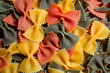 Uncooked Vibrant Colored Farfalle Pasta: A Culinary Canvas of Multicolored Bow-Tie Macaroni,...