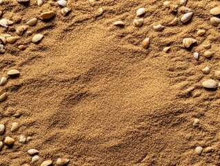 Fototapeta na wymiar A close-up view of fine sand with scattered small pebbles, showcasing the texture and natural patterns in earthy tones
