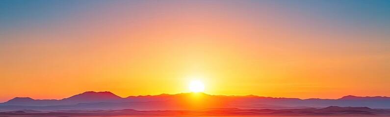 Obraz premium Stunning sunset over a vast landscape with mountains in the distance.