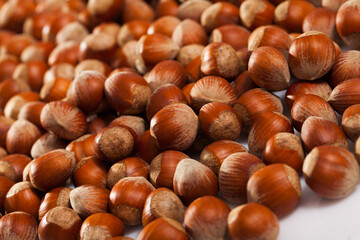 Natural background of unshelled raw hazelnuts. Healthy and nutritious snack..