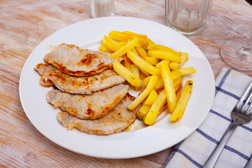 Juicy roasted loin chops served with french fries