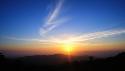 Obraz premium view of a sunset with a cloud in the sky