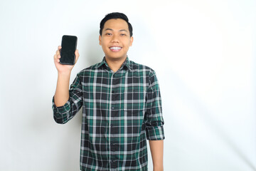 attractive asian man smiling happy while showing smartphone screen isolated on white background