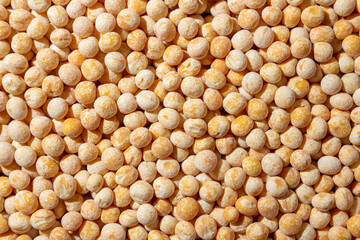 Uncooked Yellow Polished Peas Background. A Culinary Canvas of Dry Yellow Peas, Creating a Lively and Textured Background for Gourmet Cooking. Scattered Raw Polished Peas. Healthy Eating Ingredients