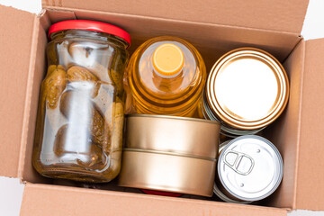 Food Reserves or Donation Box: Carton Box with Canned Food, Cereals and Grocery. Emergency Food Storage in Case of Crisis. Free Social Help, Blessings and Care. Strategic Food Supplies