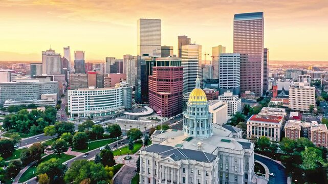 Aerial view of Colorado Capitol and Denver, Colorado skyline at sunset with slow forward motion. Denver is the capital, and most populous city of the US state of Colorado