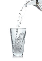 Pouring soda water from jug into glass on white background