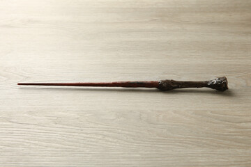 One magic wand on light wooden table