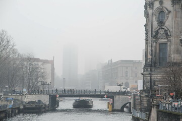 canal view of the city of Berlin in fog