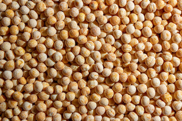 Uncooked Yellow Polished Peas Background. A Culinary Canvas of Dry Yellow Peas, Creating a Lively and Textured Background for Gourmet Cooking. Scattered Raw Polished Peas. Healthy Eating Ingredients