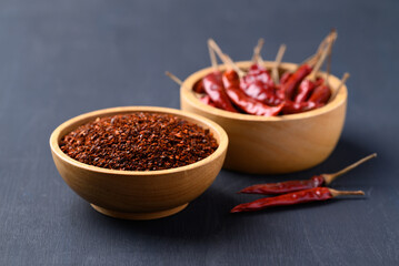 Red chili powder in bowl on black background, Food ingredient