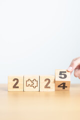2024 year change to 2025 year block with jigsaw puzzle icon. Business Process, Team, teamwork,...