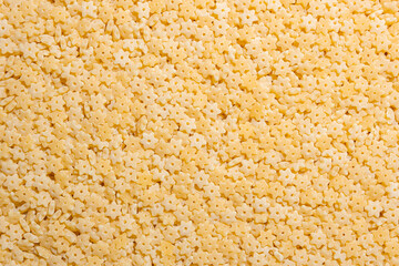 Uncooked Stelline Pasta: A Culinary Canvas of Stelline Macaroni, Creating a Lively and Textured Background for Gourmet Cooking. Dry Pasta. Raw Macaroni - Top View, Flat Lay