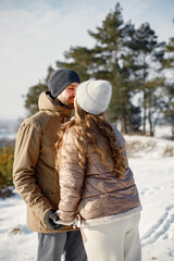 Young man and woman spending time together at winter day