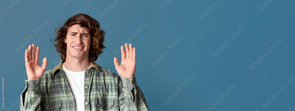 Wall mural Millennial guy with disgusted face showing denial gesture on turquoise background