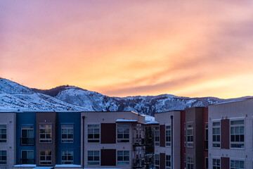 Avon, Colorado small town Mountain in winter snow view of Rocky Mountains and modern apartment architecture by Vail with dramatic sky