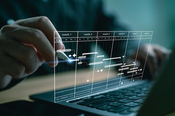 Project manager working with Gantt chart schedule to plan tasks and deliverables. Scheduling...