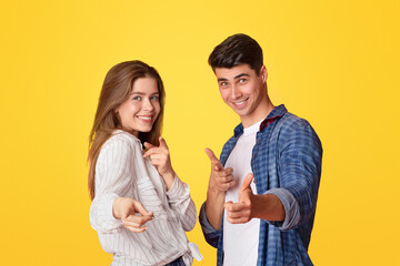 We did it and you can do it. Funny lucky millennial man and woman point fingers at camera and...