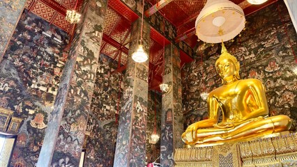 This serene Buddha statue in meditation posture under a white ceremonial umbrella sits within the historic Wat Suthat temple Bangkok perfect for illustrating Buddhist culture and tranquility