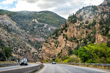Glenwood Springs, Colorado interstate highway 70 road with cars driving by ski resort town in...