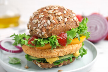Delicious vegan burger with chickpea cutlet on white table, closeup