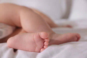 Cute little baby sleeping on bed at home, closeup