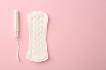 Menstrual pad and tampon on light pink background, top view. Space for text © New Africa