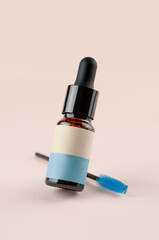 Mockup of a glass bottle with a dropper. Cosmetology products eyebrow oil. Blank label. Place for inscription and logo.