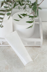 Tube with cream on the table.  Product packaging mockup. white. .Empty white tube with cream. Place for logo and text. Top view.