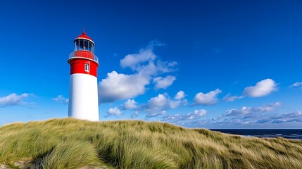 Coastal Lighthouse Stands Tall Against Blue Sky